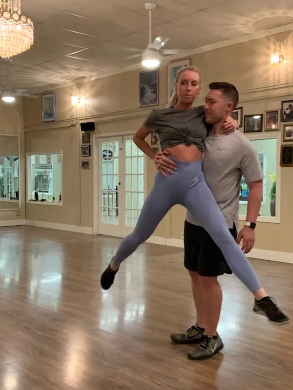 An overhead lift being practised in the studio