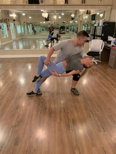 A couple in a deep dip during a studio lesson