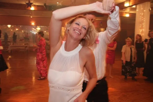 A woman dancing with her instructor in the studio