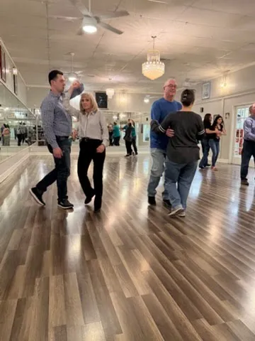 Couples dancing together in a group class