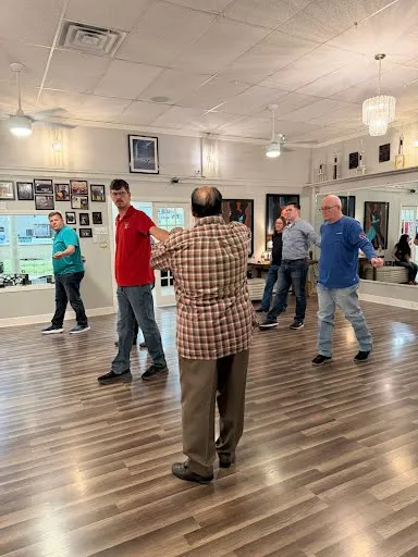 Dancers on the studio floor at the end of a class