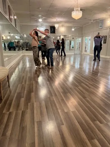 Couples dancing together during a group class
