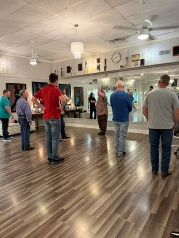 A couple dancing on the studio floor