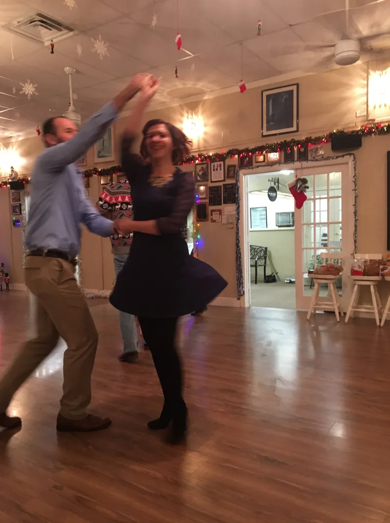 A couple dancing in the studio, decorated for Christmas