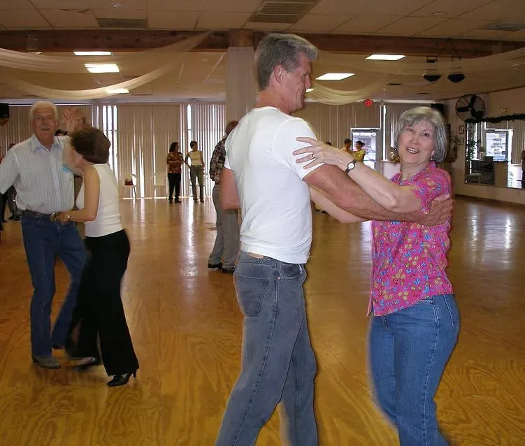 Couples dancing on a wooden ballroom floor