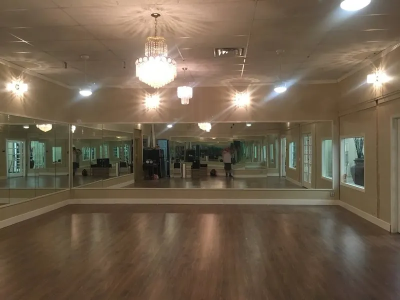 The empty ballroom floor under its chandeliers