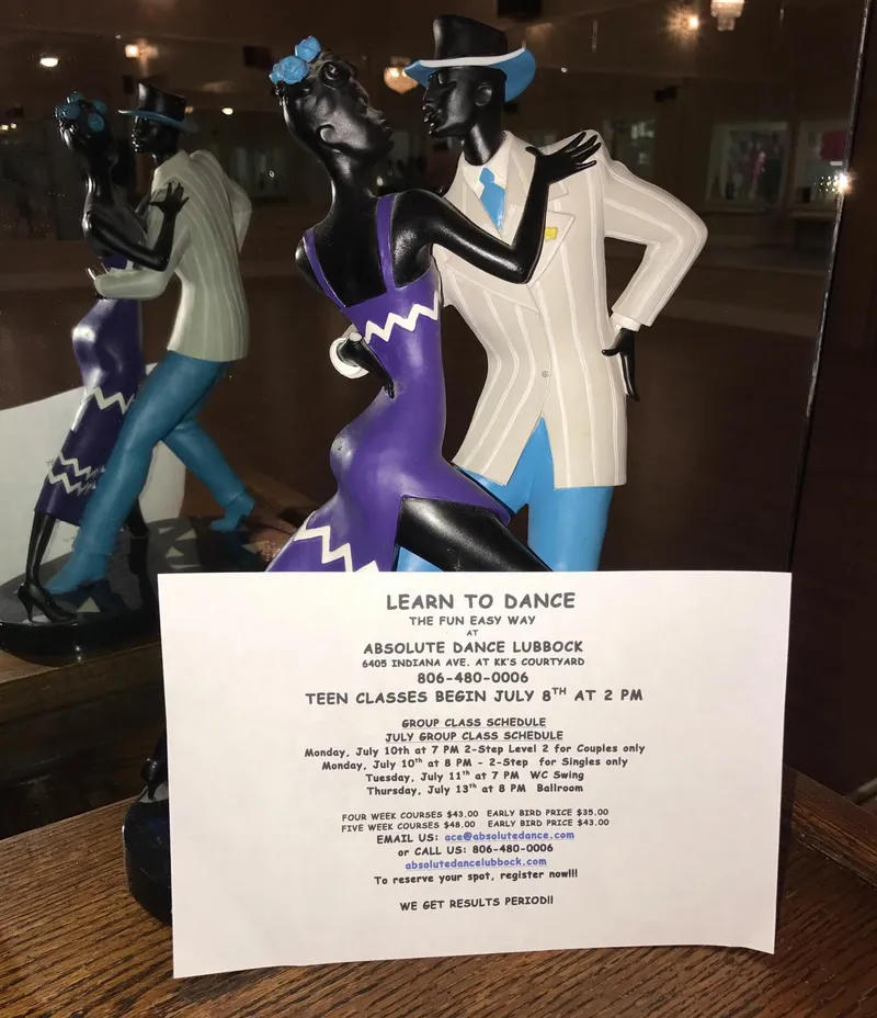 A “Learn to Dance” flyer beside a sculpture of a dancing couple