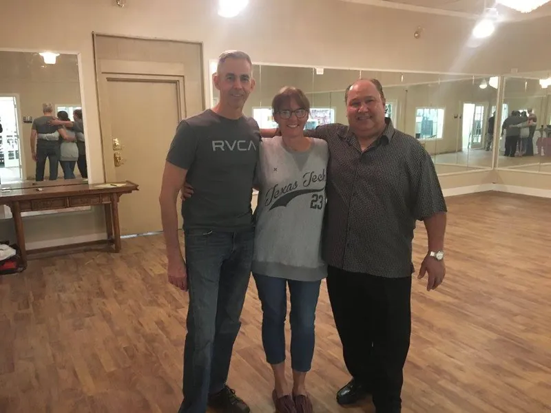 Three people standing together on the studio floor