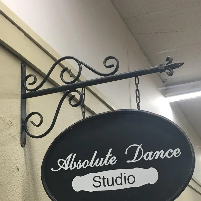 The hanging “Absolute Dance Studio” sign outside the studio